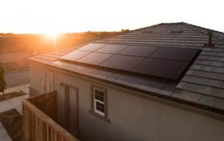 Evergreen Residential Solar array on a house rooftop during a sunset or sunrise