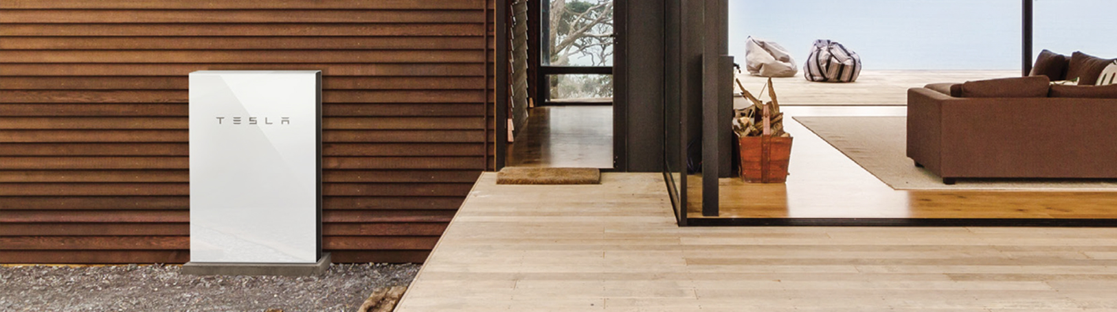 A Tesla Powerwall battery system on the outside of a modern minimal stylish house 