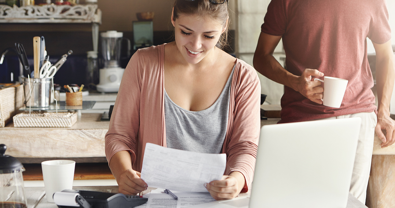 Girl smiling while managing bills and maximizing solar savings