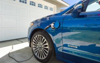 An electric vehicle is being charged from the garage of home.