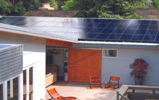 Modern home with solar panels on the roof, illustrating cost-effective solar energy solutions for 2023 by Home & Energy Solutions of Florida.