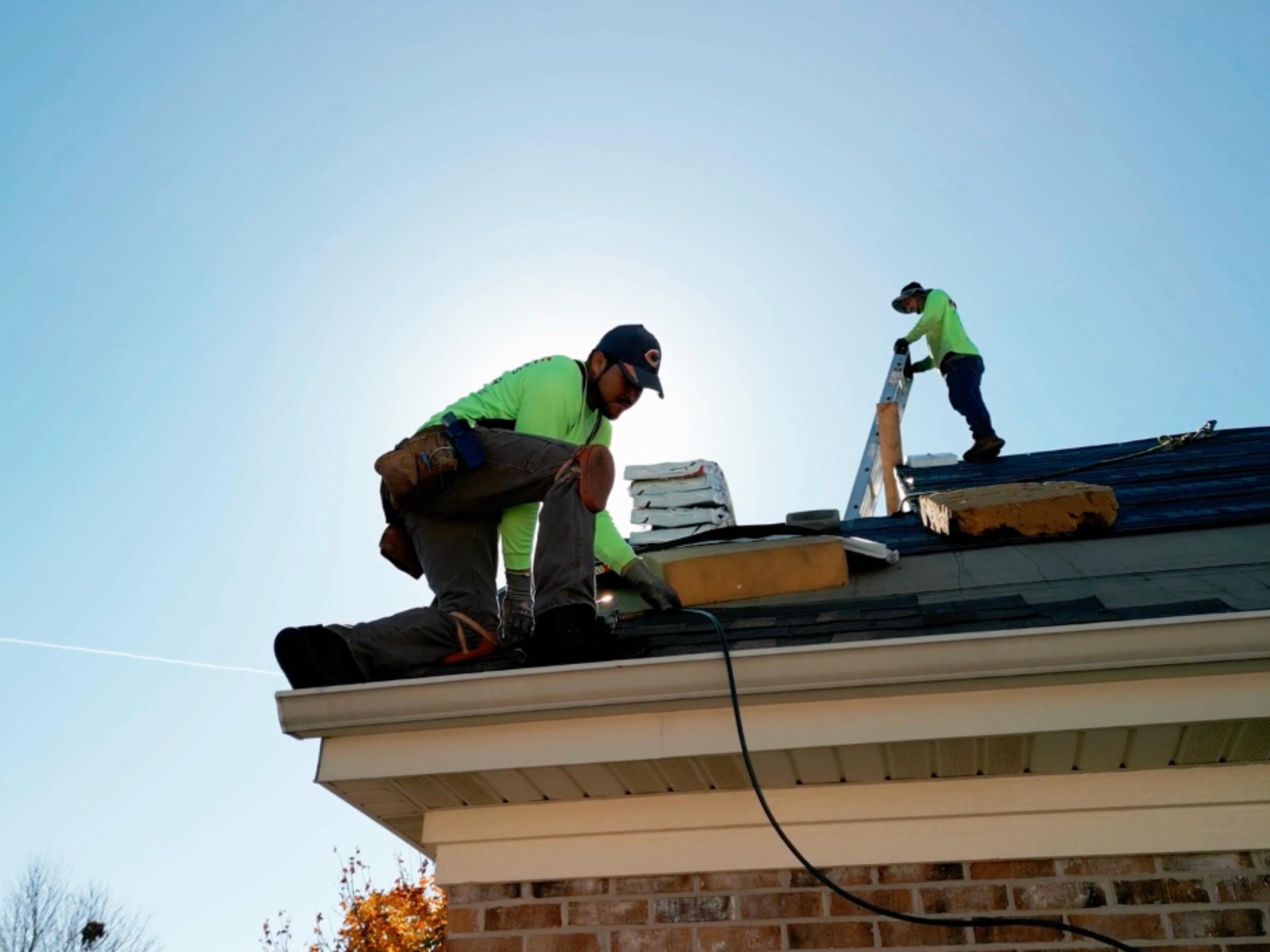 workers on the roof of a home workers on the roof of a home